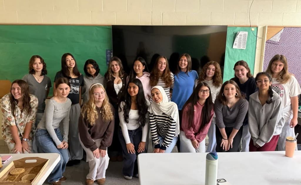 HER students in a busy classroom during a presentation