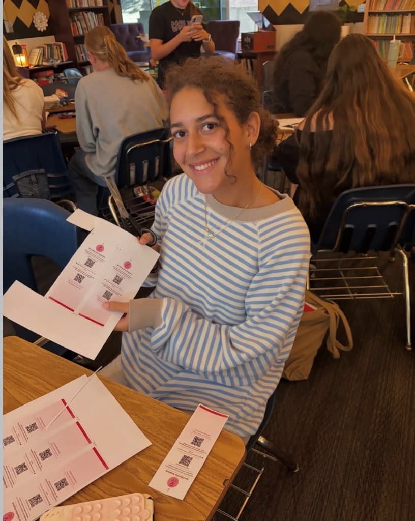 Student cutting History by HER bookmark printouts