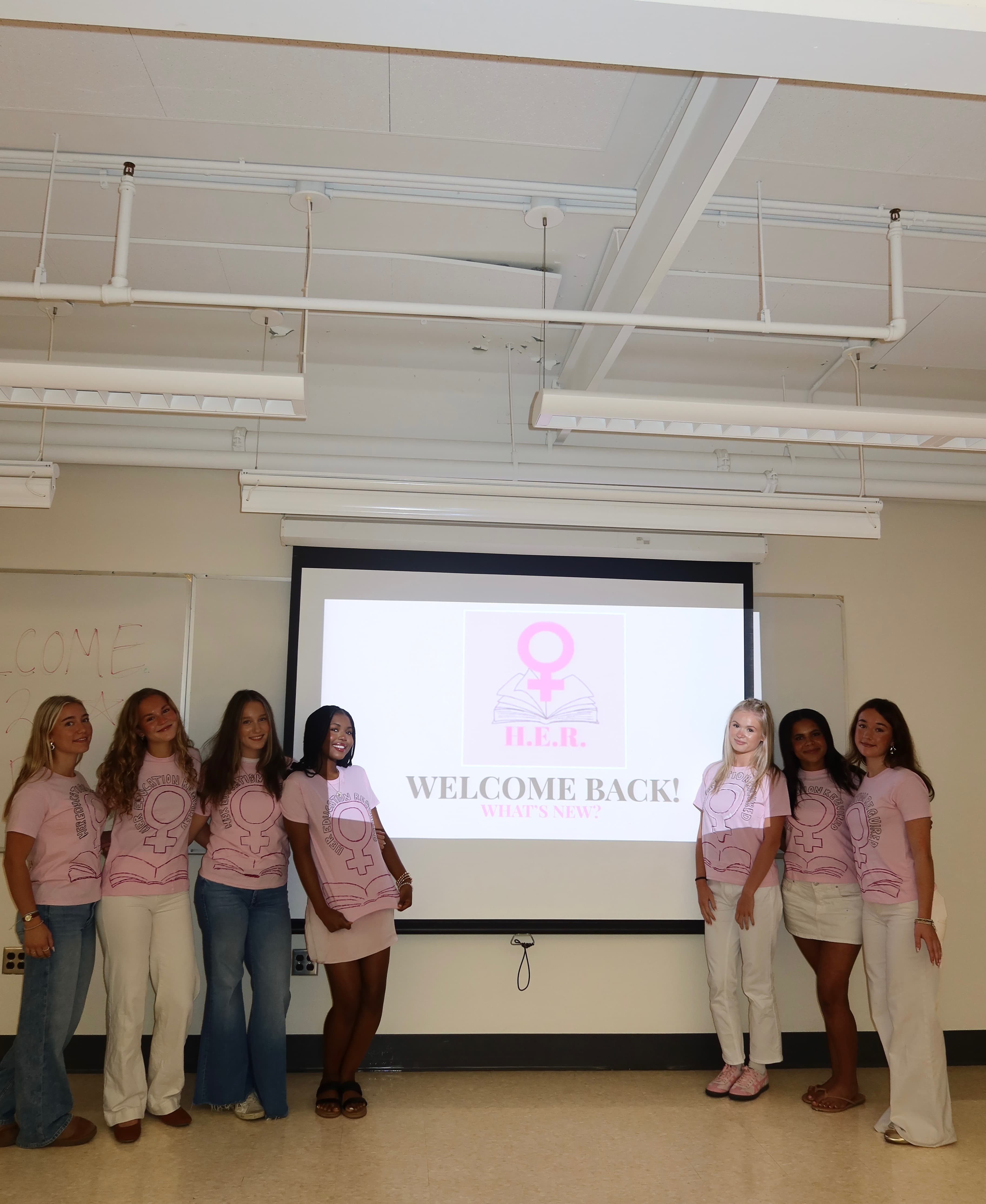 HER students in pink shirts at a Welcome Back meeting