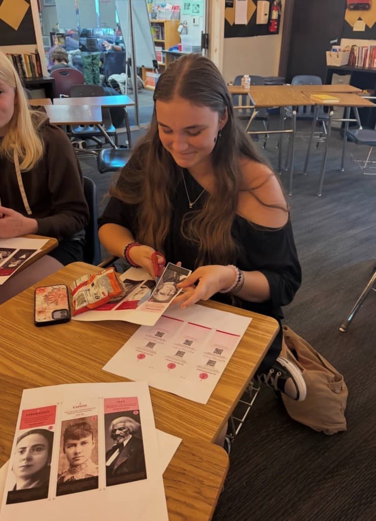Student placing HER bookmarks in a school library display