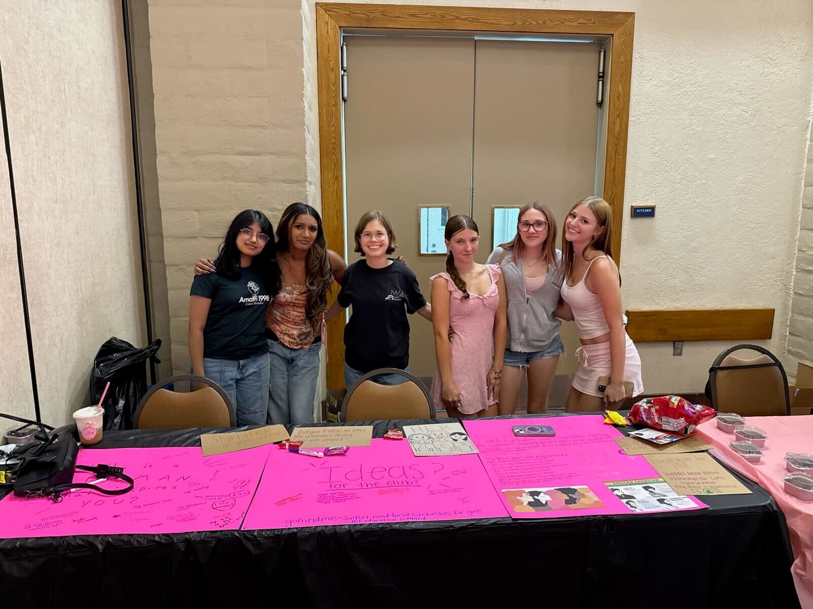 HER students with a photo booth frame