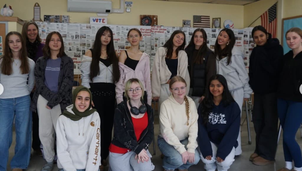 South Burlington High School HER club group photo in classroom