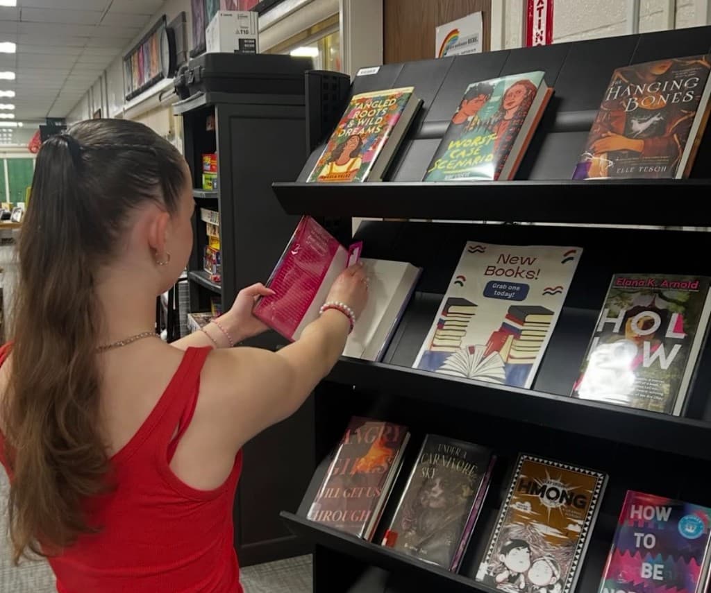 Student browsing books while placing HER materials