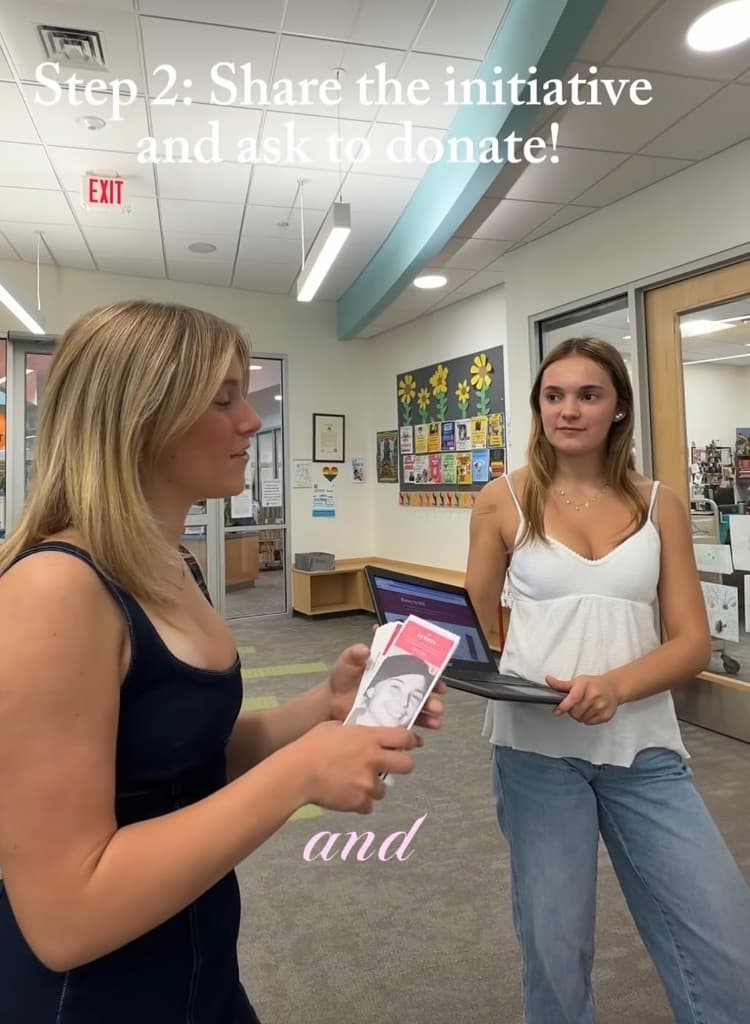 Volunteers sharing History by HER and asking to donate bookmarks